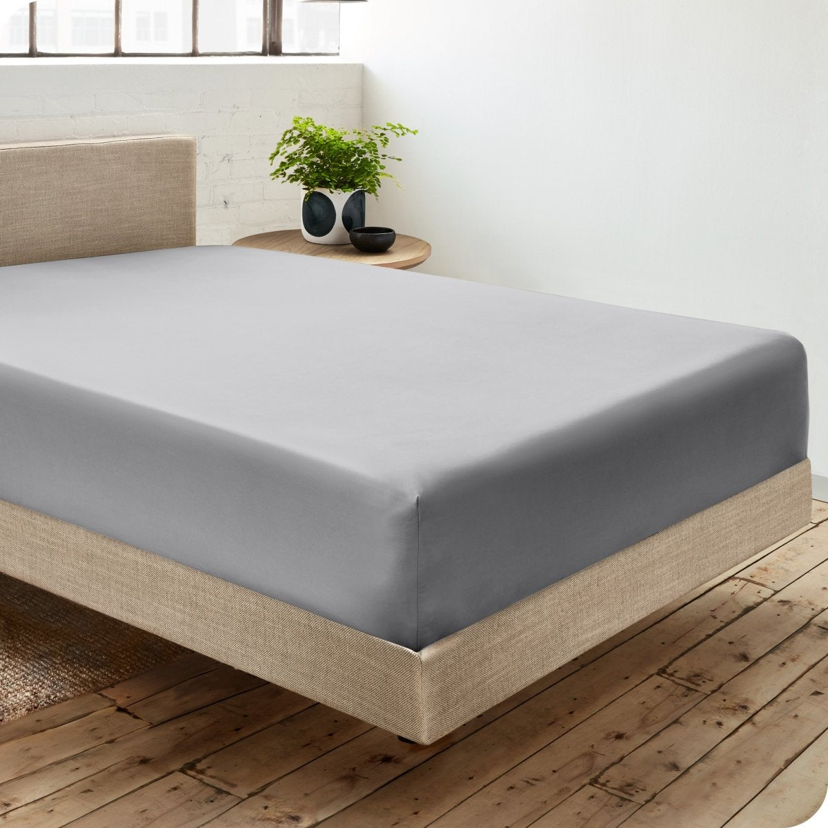 Diagonal view of room scene with percale fitted sheet on the bed