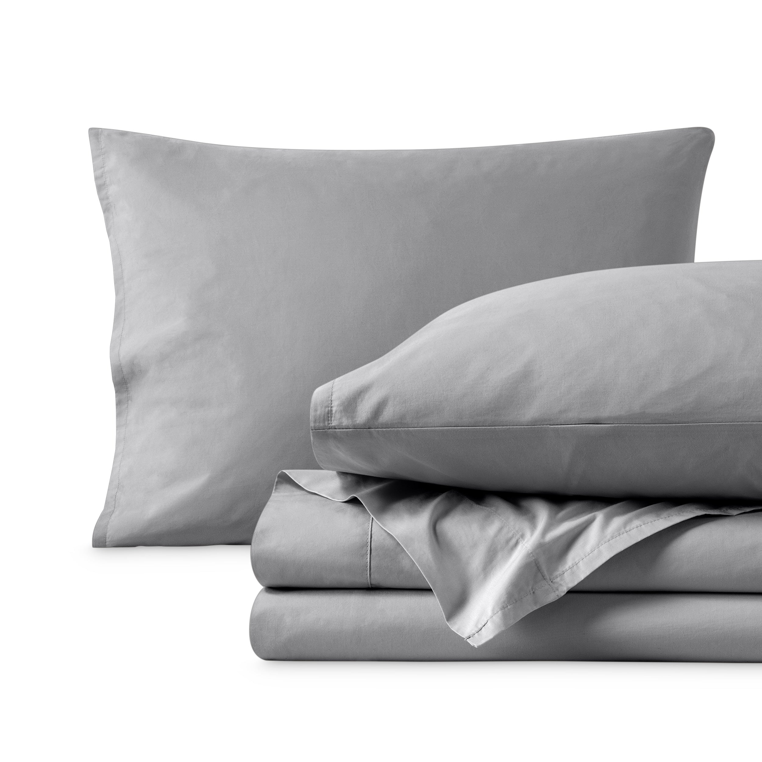 Percale sheets folded and matching pillowcases with pillows in them