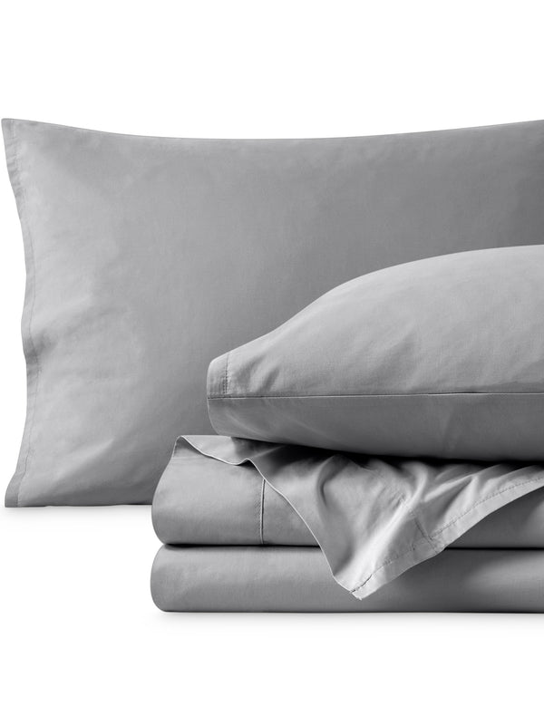Percale sheets folded and matching pillowcases with pillows in them