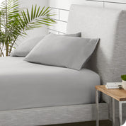 A sideview of a modern bed with a polar fleece fitted sheet on.