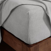 Corner of a mattress with a fitted sheet on it