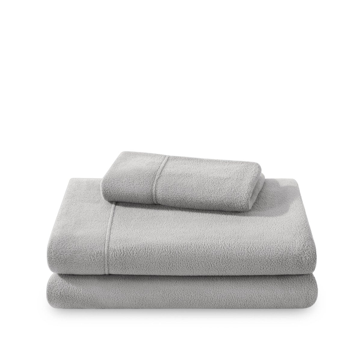 Polar fleece sheets and pillowcases folded and stacked on a white background