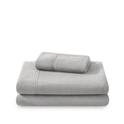 Polar fleece sheets and pillowcases folded and stacked on a white background