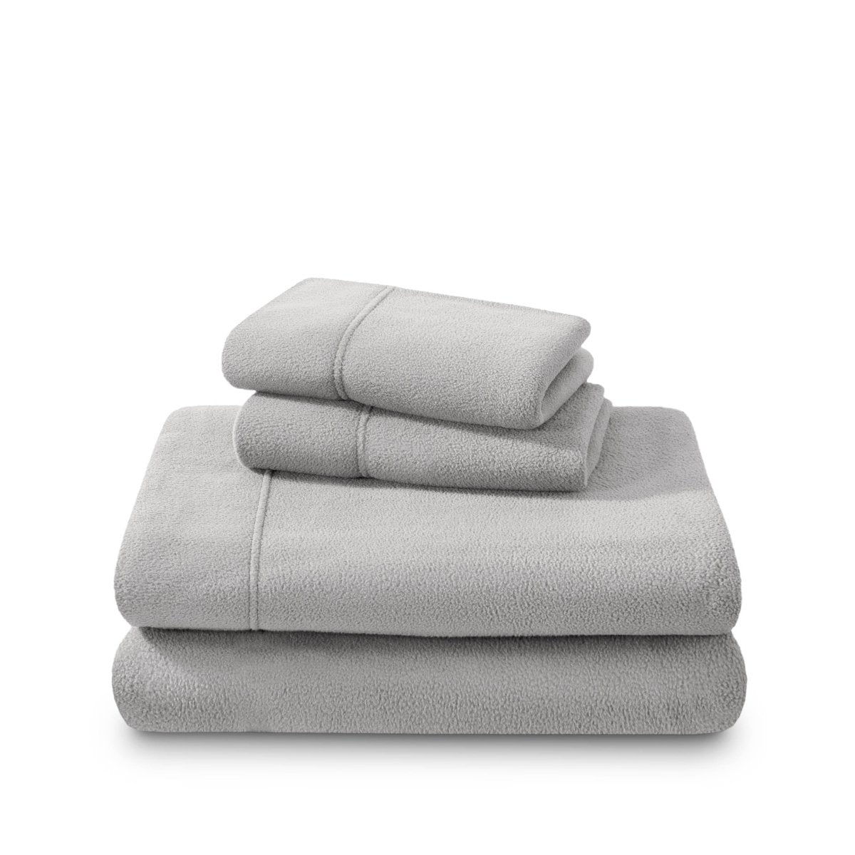 Polar fleece sheets and pillowcases folded and stacked on a white background