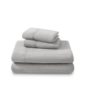 Polar fleece sheets and pillowcases folded and stacked on a white background
