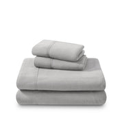 Polar fleece sheets and pillowcases folded and stacked on a white background