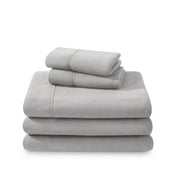 Polar fleece sheets and pillowcases folded and stacked on a white background