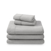 Polar fleece sheets and pillowcases folded and stacked on a white background