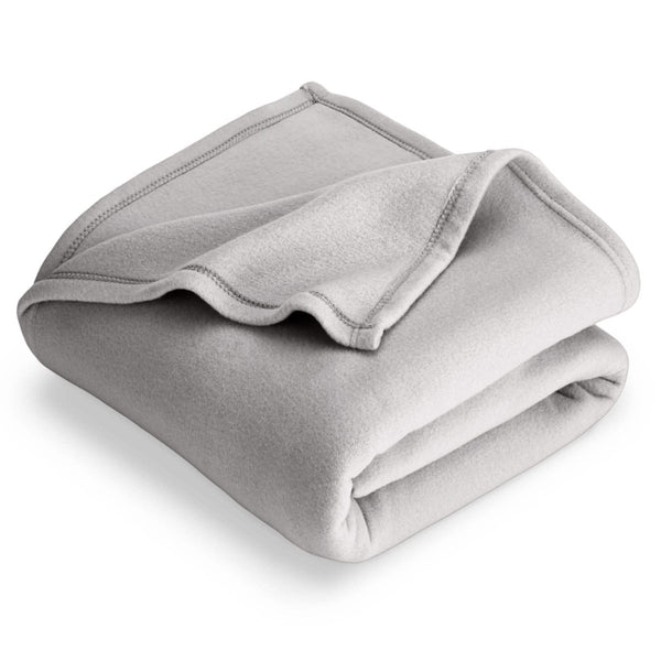 Light grey polar fleece blanket folded with 1 corner folded back