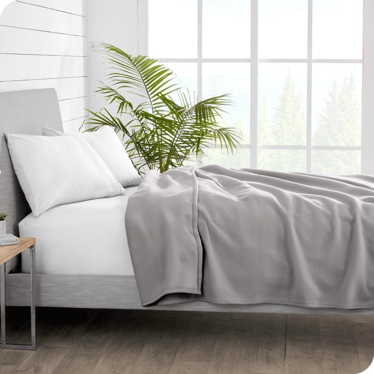 Side view of bed with polar fleece blanket laid out on the bed and pulled up to pillows