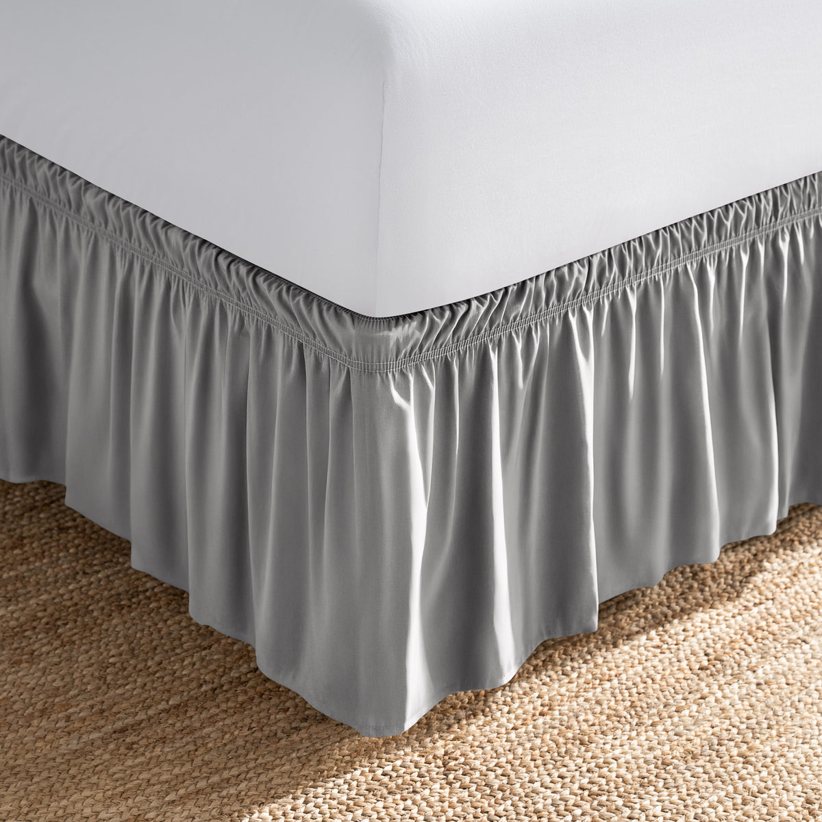 Bed with white fitted sheet and an adjustable bed skirt.
