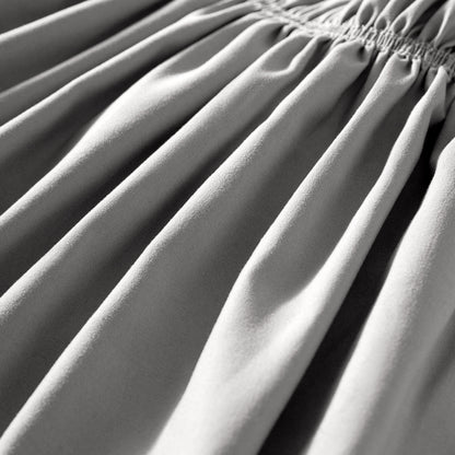 Close-up of polyester bed skirt fabric with a focus on texture and folds.