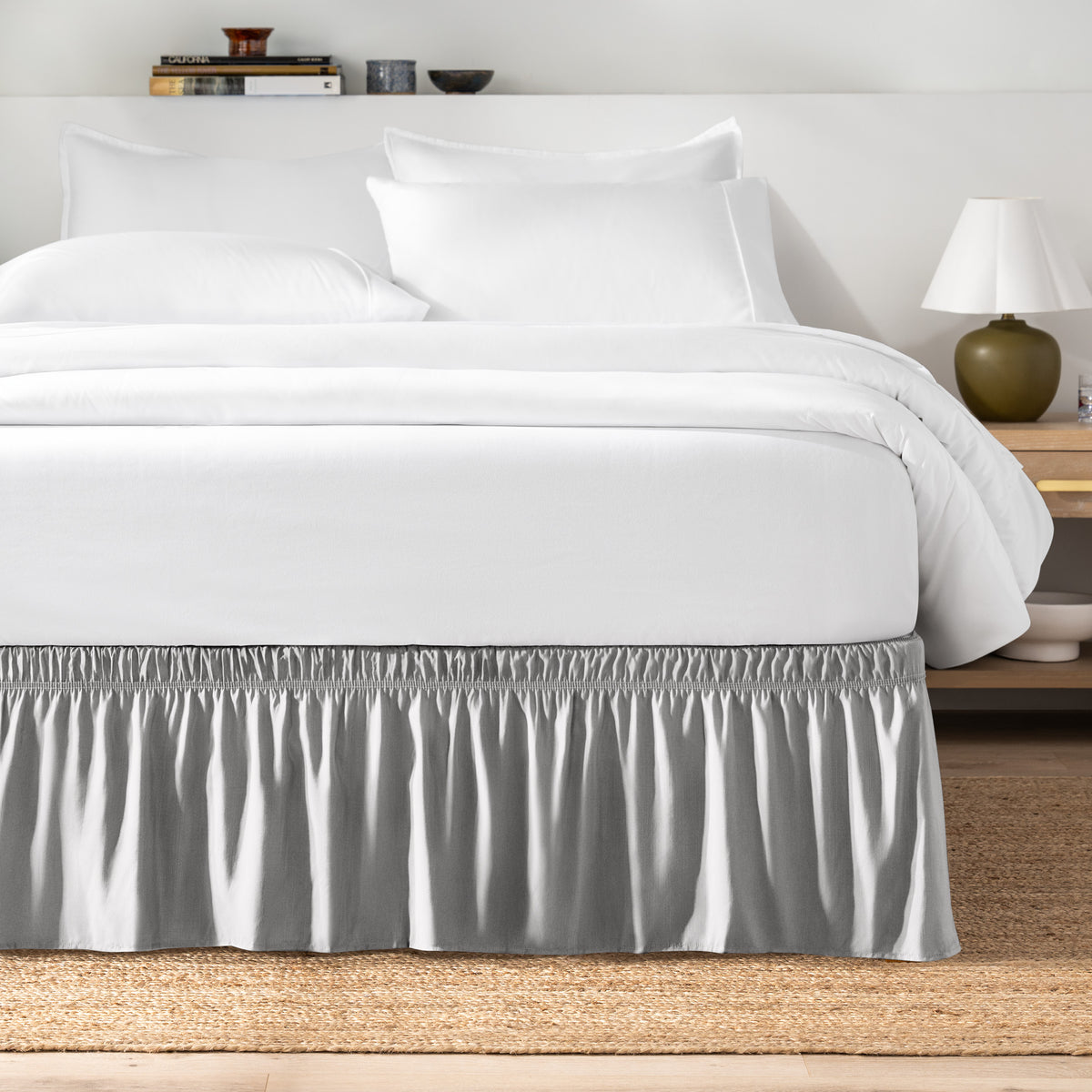 Bed with white bedding and a bed skirt.