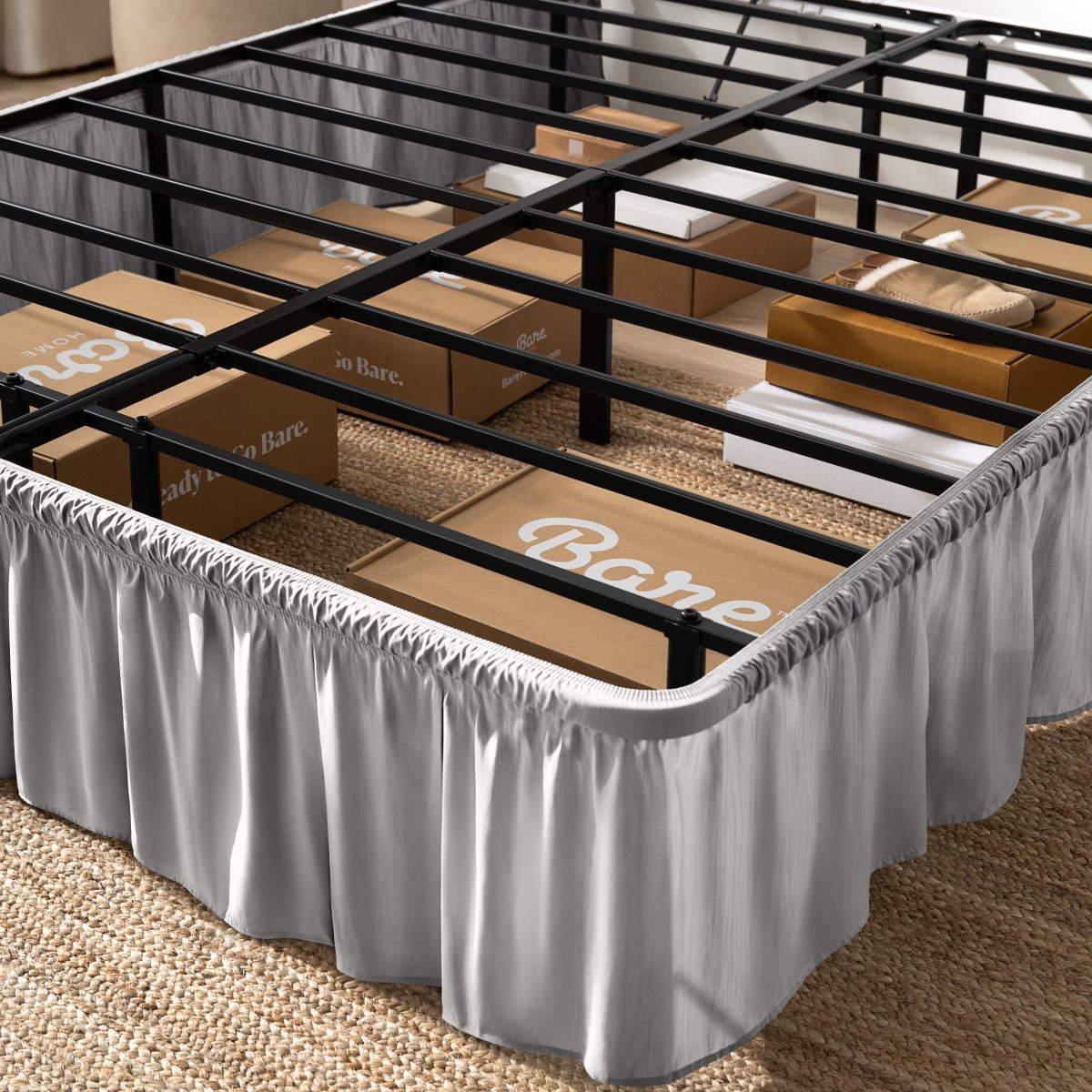 Bed frame with bed skirt and Bare Home boxes underneath.