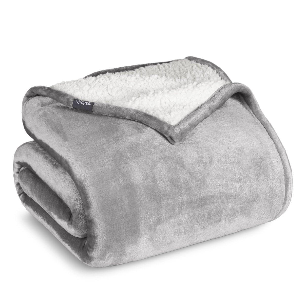 Fleece blanket with white sherpa lining on a white background.