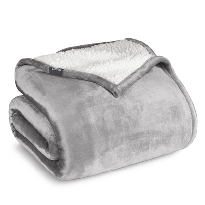 A sherpa blanket folded neatly while showing both sides