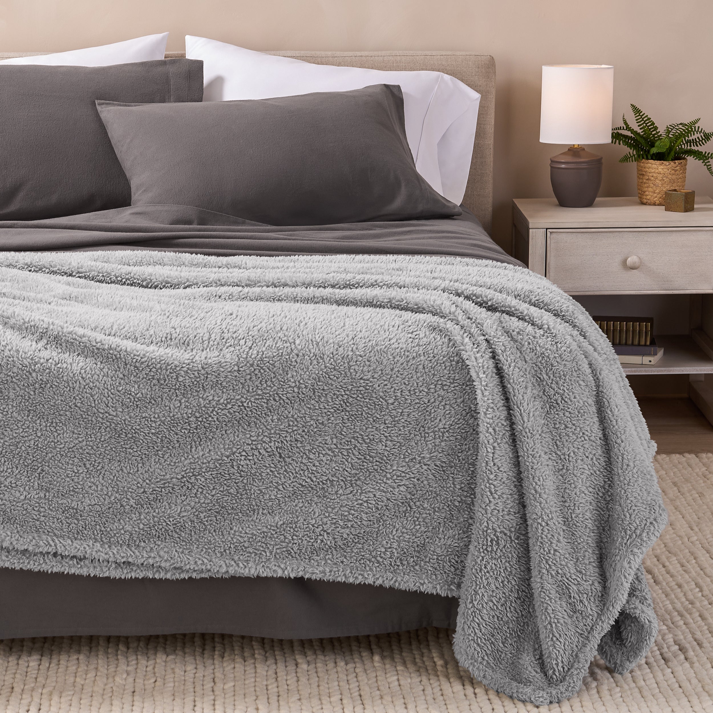 A double sided sherpa blanket on a bed