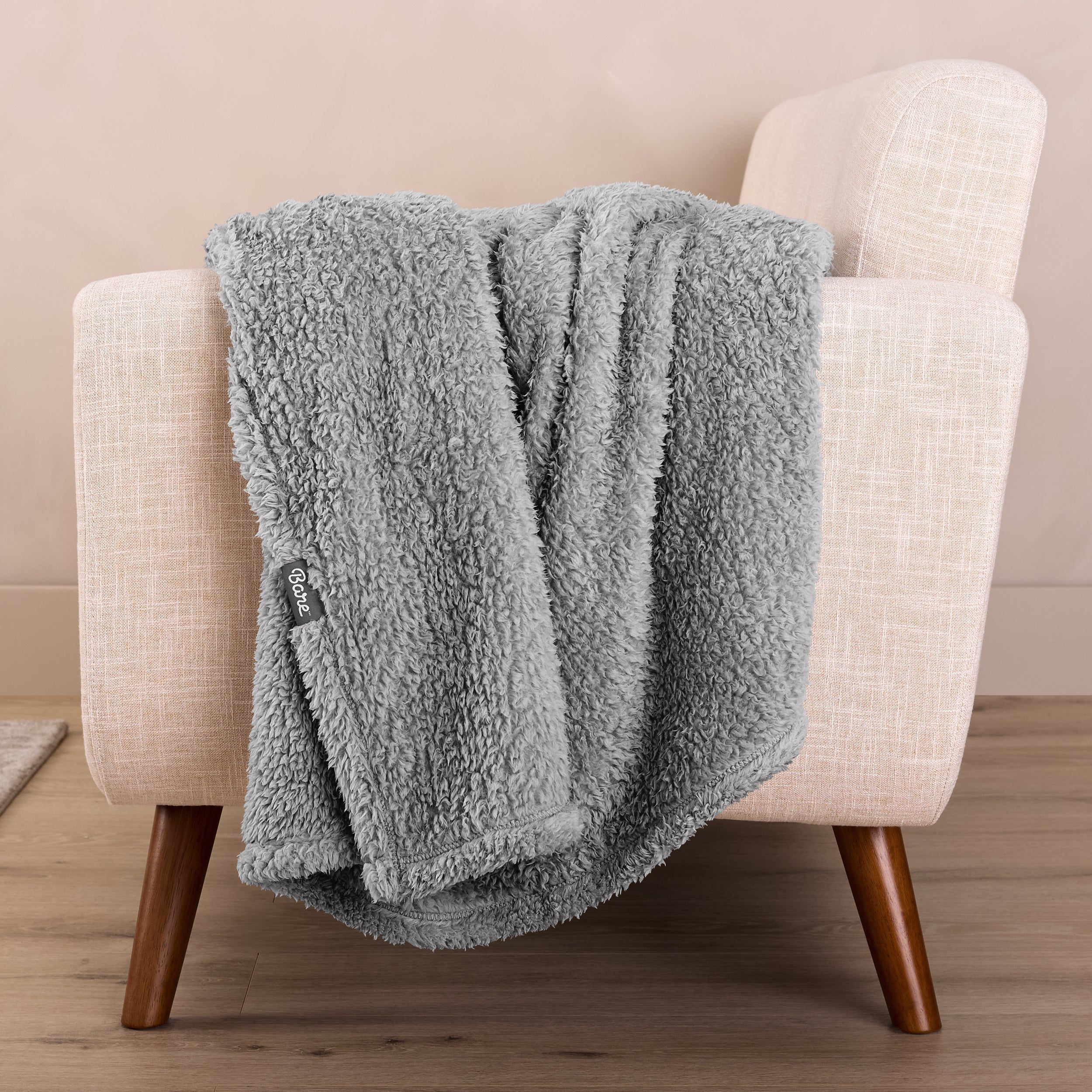 A sherpa blanket draped over a chair