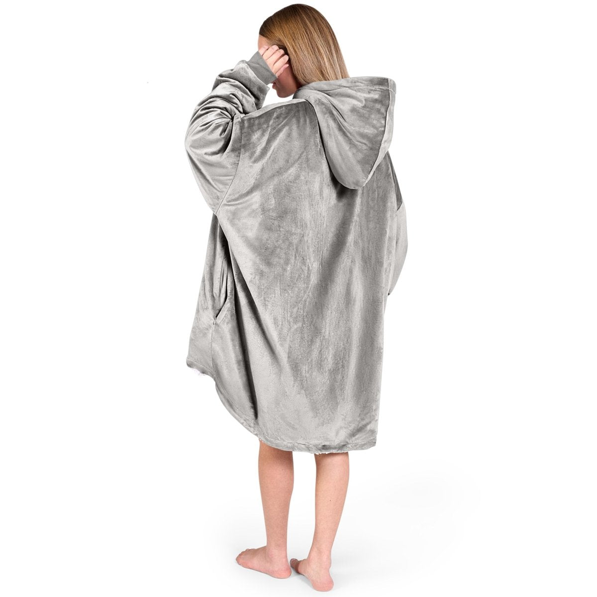 An adult with a hooded wearable blanket on