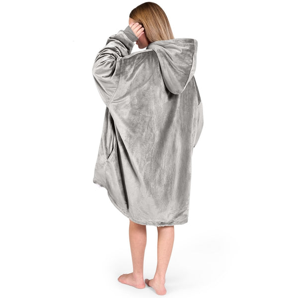 An adult with a hooded wearable blanket on