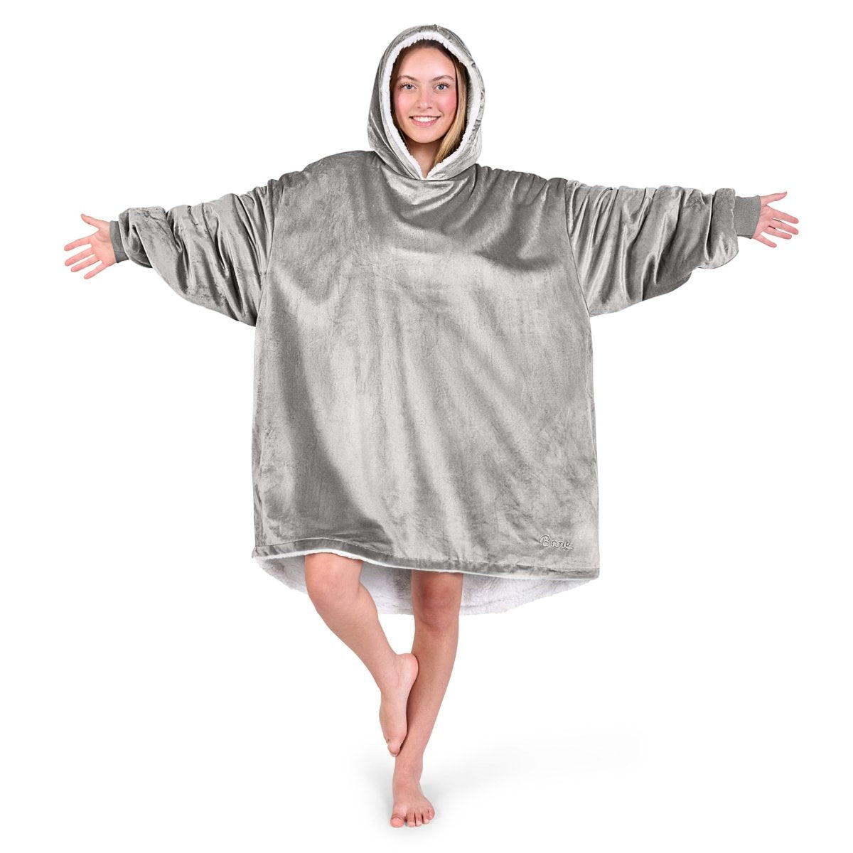 An adult with a hooded wearable blanket on
