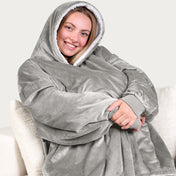 An adult with a hooded wearable blanket on
