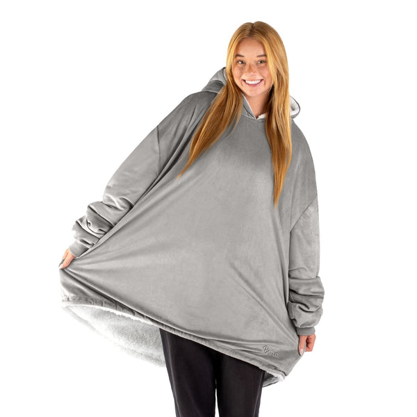 An adult with a sherpa wearable blanket on