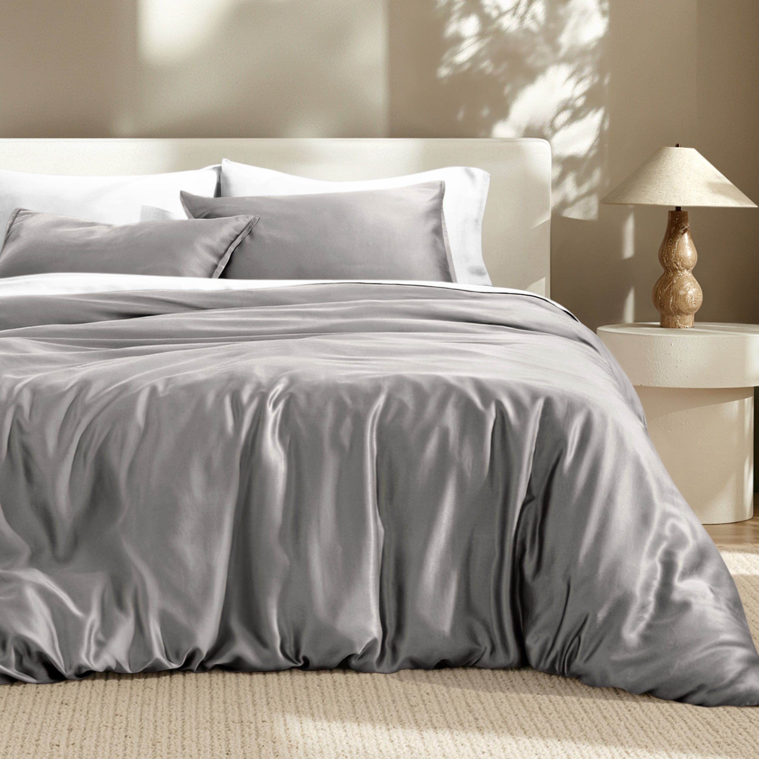 Bedding set on a bed with a lamp in the background