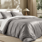 Bedding set on a bed in a bedroom with a lamp and window.