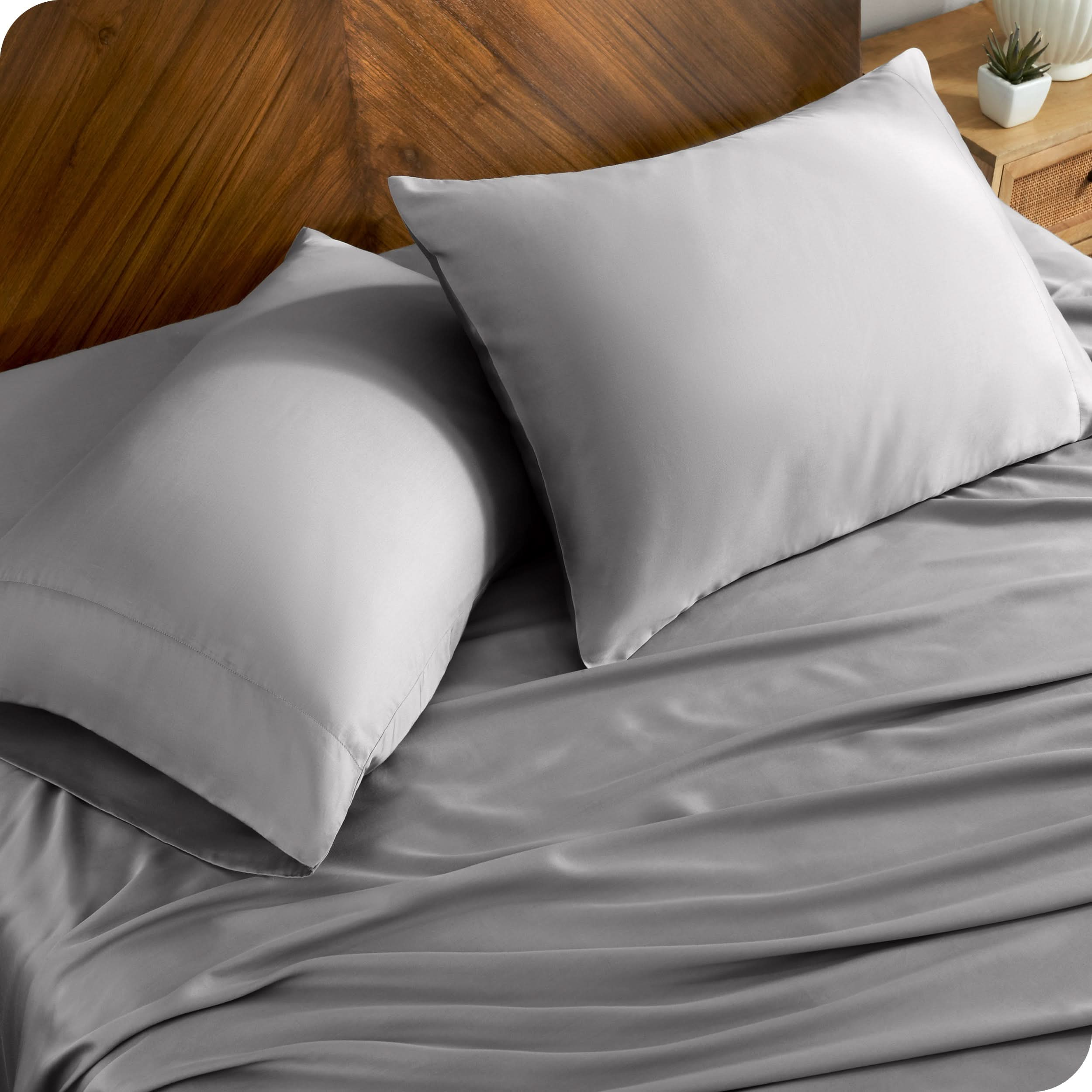 TENCEL™ pillowcases on pillows near a wooden headboard