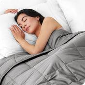 A woman sleeping with a weighted blanket over her body
