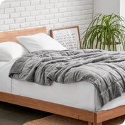 A weighted blanket draped over a bed
