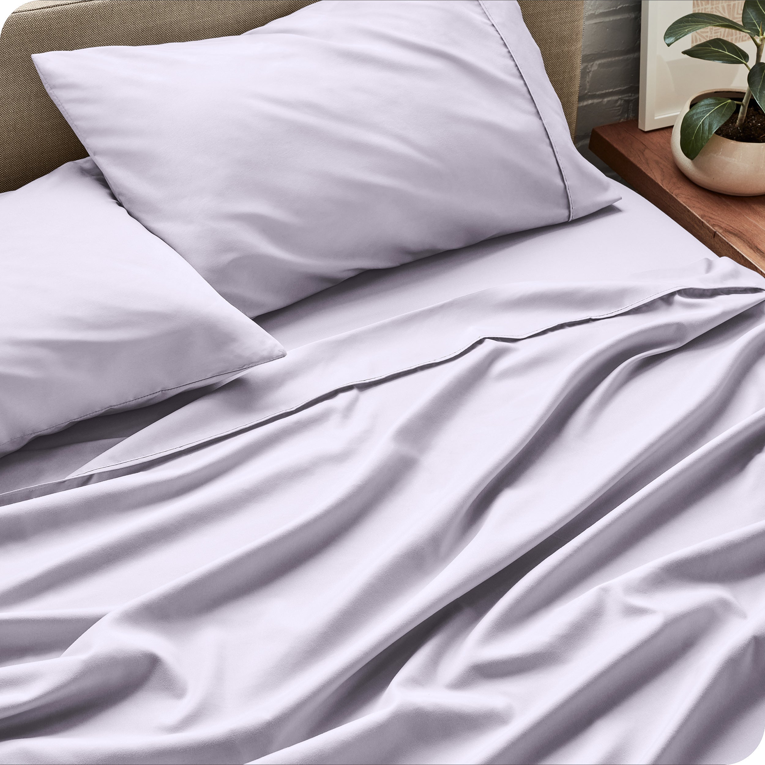 Sheets and a duvet cover on a bed in a bright bedroom