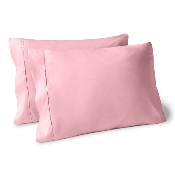 Two pillows on a white background with pillowcases on them