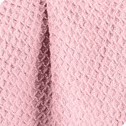 Close up of the fabric of a cotton waffle blanket