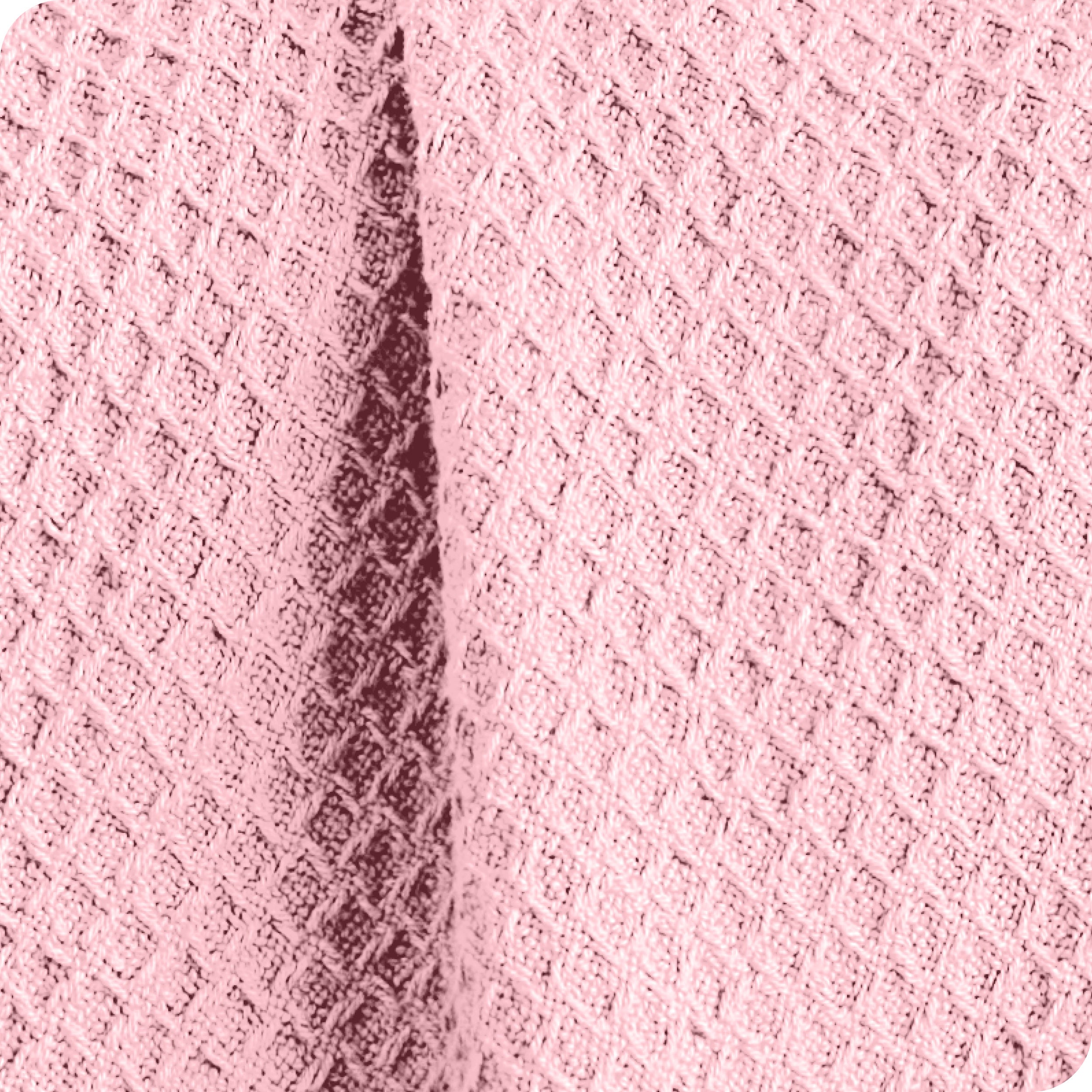 Close up of the fabric of a cotton waffle blanket