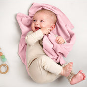 A baby lying on a flannel receiving blanket