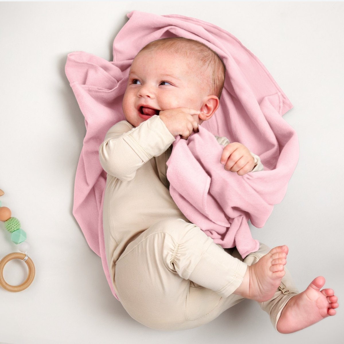 A baby lying on a flannel receiving blanket