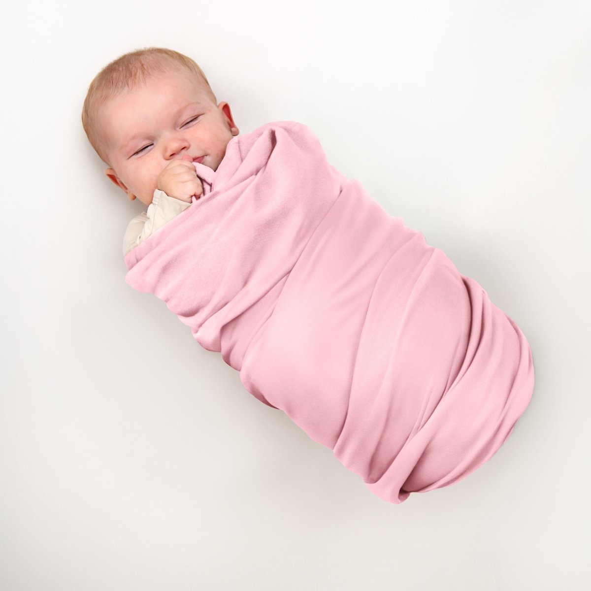 A baby wrapped in a flannel receiving blanket