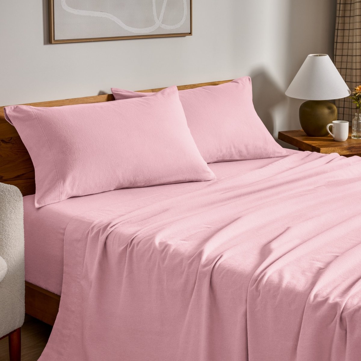 Flannel bed sheets and pillowcases on a bed in a bedroom setting.