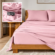 Bed with flannel bedding and wooden headboard and nightstand next to it.