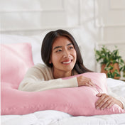 Woman lying on abed with a silk pillowcase
