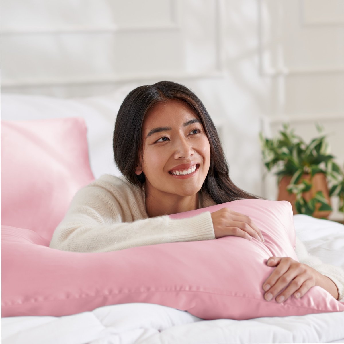 Woman lying on abed with a silk pillowcase