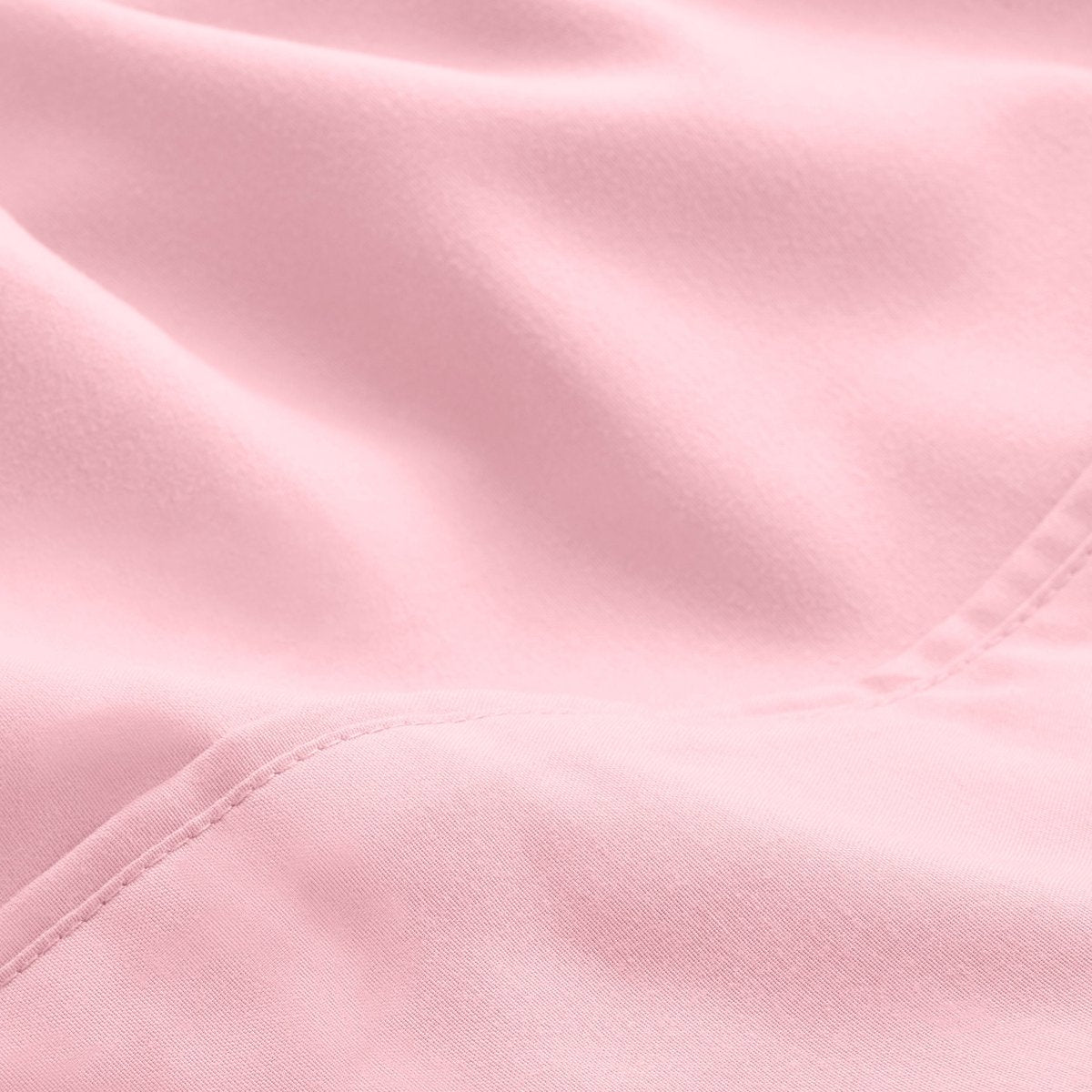 A close-up of microfiber fabric with soft folds and a visible stitched seam.