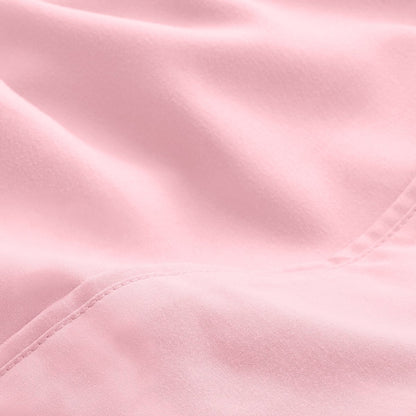 A close-up of microfiber fabric with soft folds and a visible stitched seam.