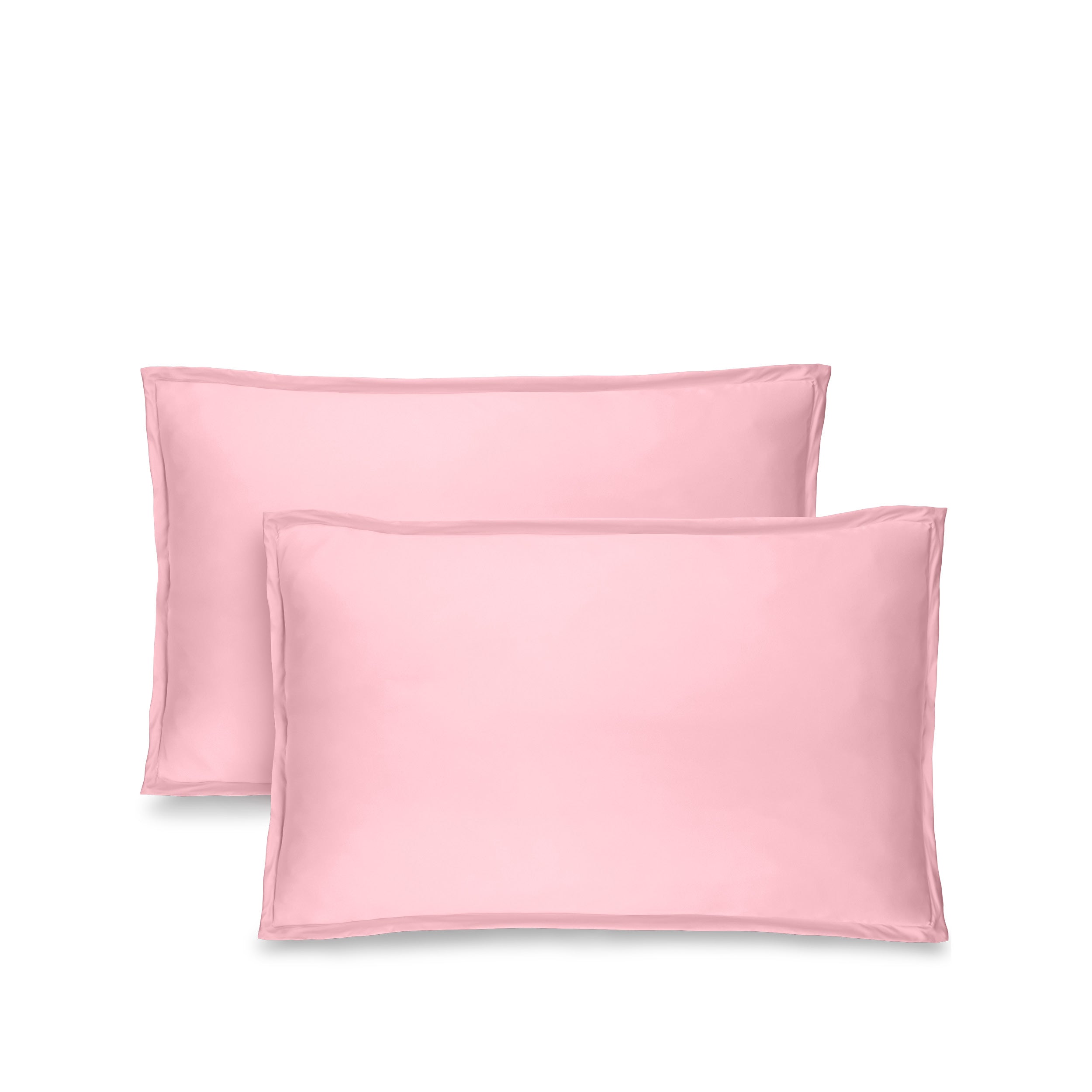 Two pink pillow shams on pillows standing up with one behind the other