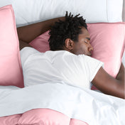 Man sleeping with his head resting on a pillow sham