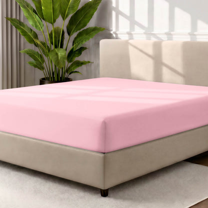 Ultra soft fitted sheet on a mattress with the sun shining into the bedroom