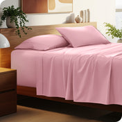 Bed with microfiber bedding and wooden headboard in a bedroom setting