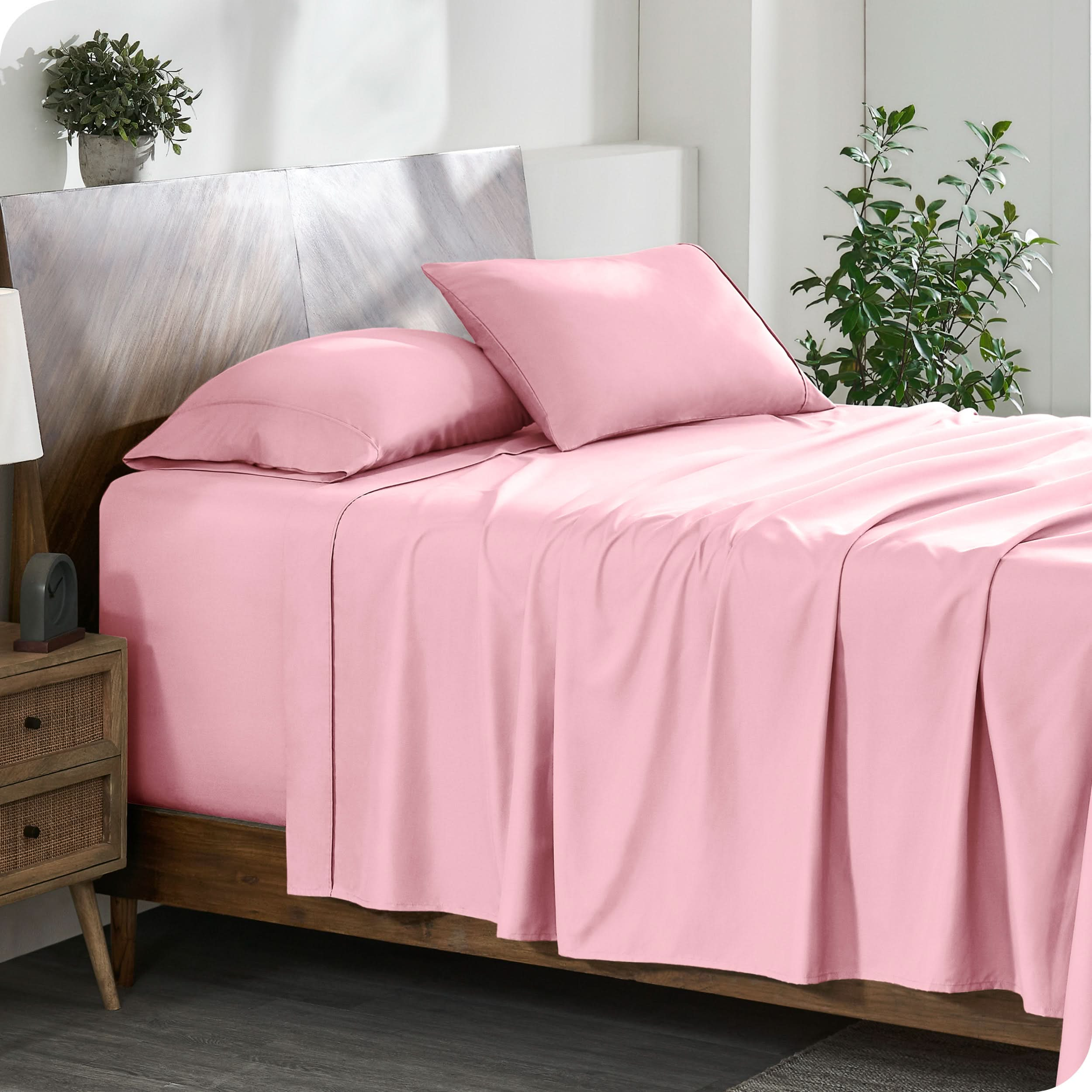 A cozy bedroom featuring a neatly made bed with soft, microfiber sheets.